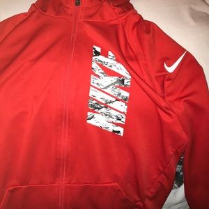 Red zip up Nike jacket.